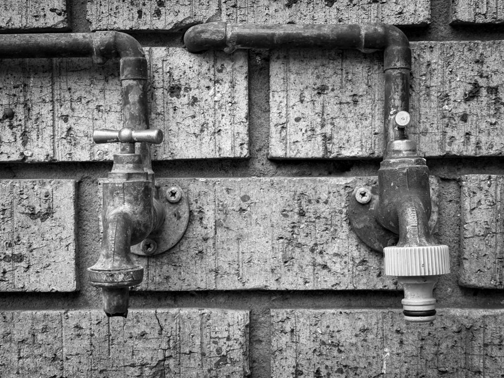 Old pipes on a brick wall