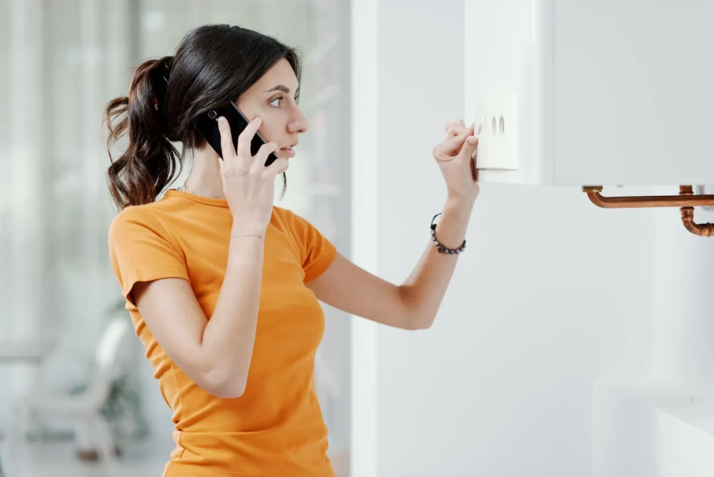 Technician diagnosing a heating problem caused by a plumbing system issue